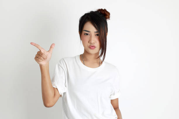 The Asian womna standing on the white background.