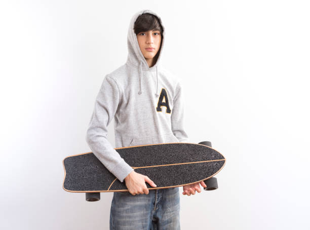 istock handsome teen boy with a longboard  on white background. 1329301603