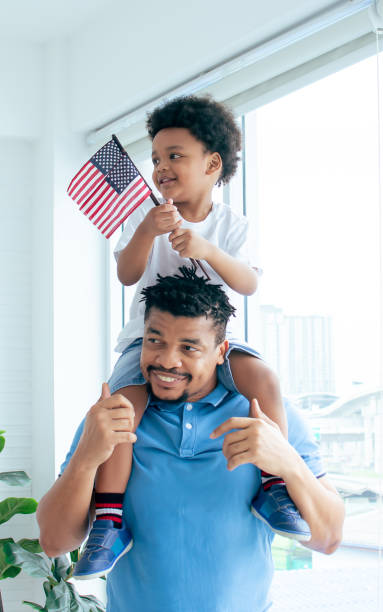 istock African father is playing with his son 1329302463