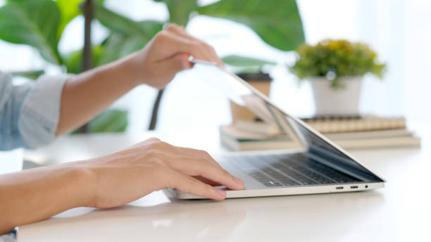istock Close up of man hand opening laptop computer while working at home office, Student college online study, learning, people and technology 1329304350