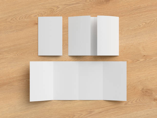 istock Vertical double gate fold brochure. Four panels, eight pages blank leaflet. Mock up on wooden background for presentation design. Folded, semi-folded and front side. 1329304496