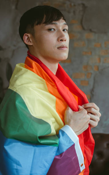 istock Asian man holding rainbow flag 1329306487