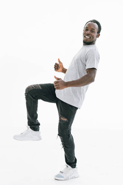 istock side view. smiling handsome guy showing thumbs up 1329306703
