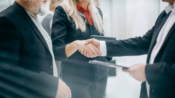istock panoramic image. business partners shake hands during negotiations 1329307342