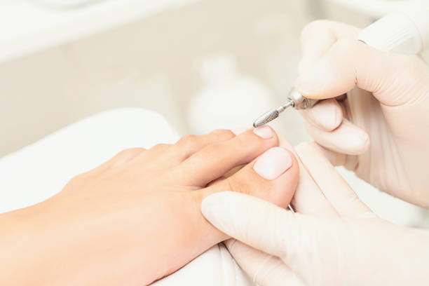 Classic pink wedding toe nail manicure on white backdrop. Spa treatment concept