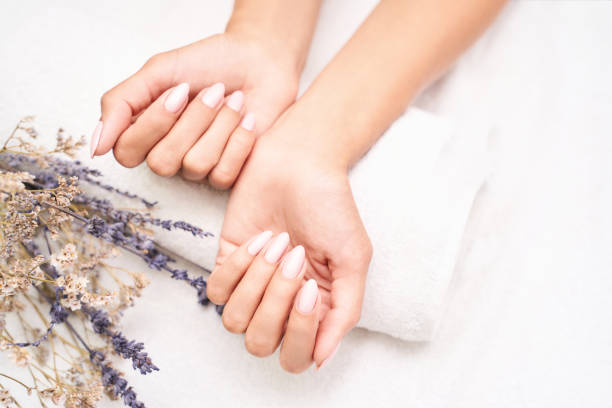 Classic pink wedding nail manicure on white backdrop. Spa treatment concept Classic pink wedding nail manicure on white backdrop. Spa treatment concept. Towel background. Natural hygiene. Health care. Beauty spa salon. Salon procedure Woman body care. Lavender flower nail salon stock pictures, royalty-free photos & images