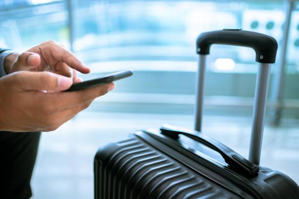 istock Asian  businessman using mobile phone at airport. 1329308985