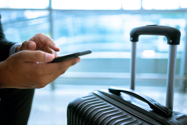 istock Businessman using online banking at the airport. 1329309097