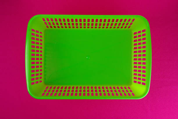 istock Plastic container without a lid of green on a pink background 1329310108