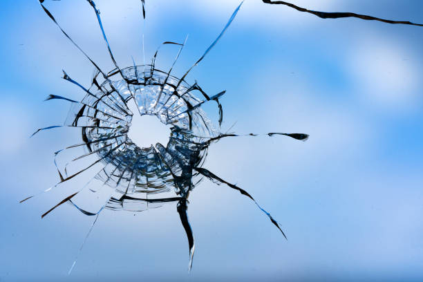 istock Cracks in the window glass on a background of sky. 1329311922