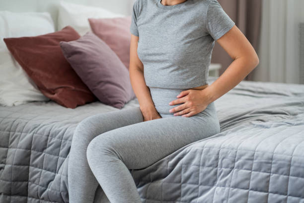 Menstrual pain, woman with stomachache suffering at home Menstrual pain, woman with stomachache suffering at home, health problems concept incontinence stock pictures, royalty-free photos & images