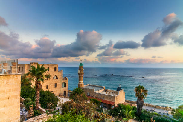 view of the sea mosque in the old town of jaffa in israel with a colorful sunrise - tel aviv imagens e fotografias de stock