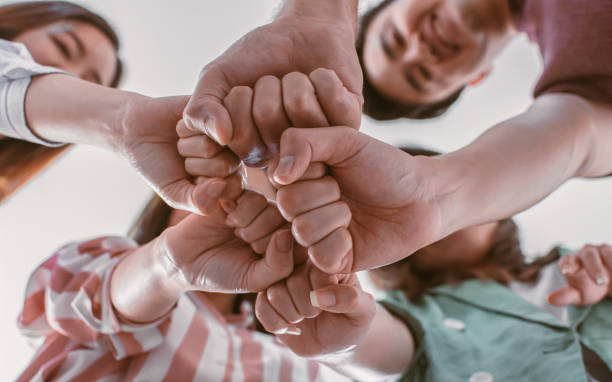 istock Selective focus and closeup on hands together showing unity and successful teamwork in job. 1329315596