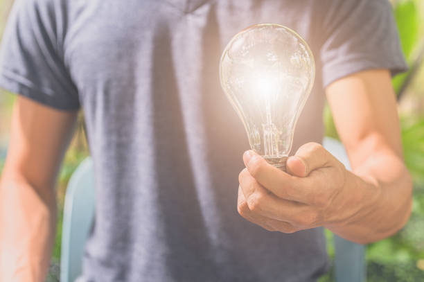 istock idea of a man holding a light bulb 1329316472