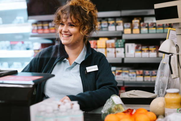 istock Supermarket cashier attending customer 1329317613
