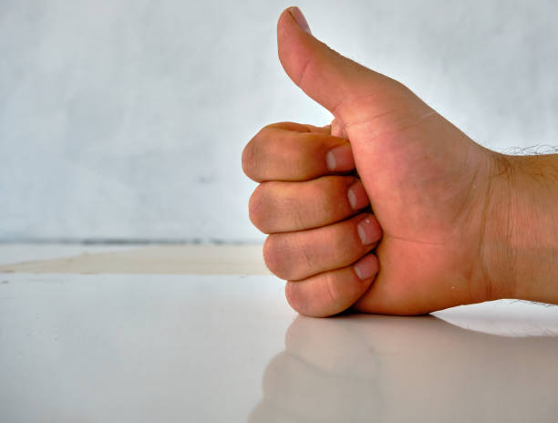 istock Hand and its shadow and reflection on the patterned wall of OKAY 1329318506