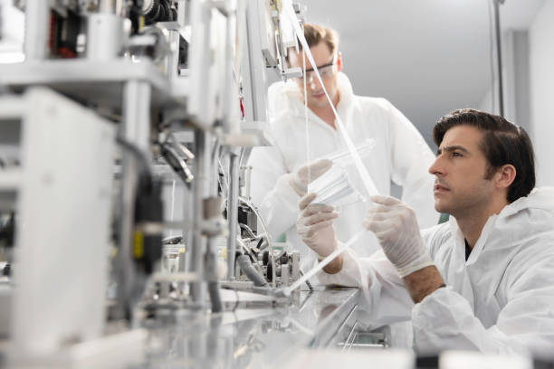 istock Technician or engineer working checking mask production machine at clean factory or laboratory, Face mask manufacturing production automation or quality concept 1329318802