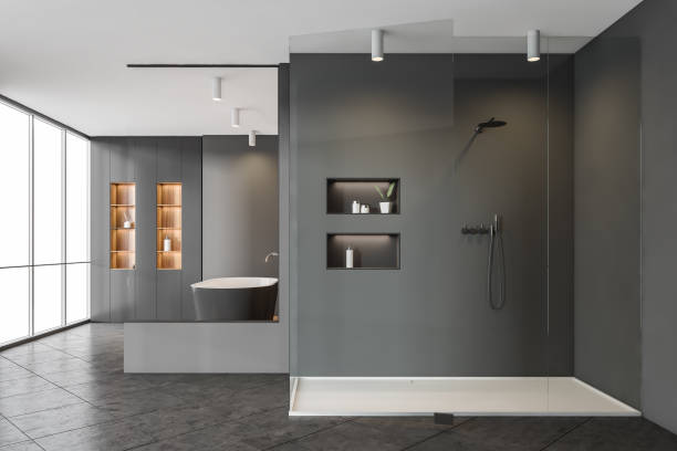 istock Dark bathroom interior with shower, bathtub with shelf near window 1329319913
