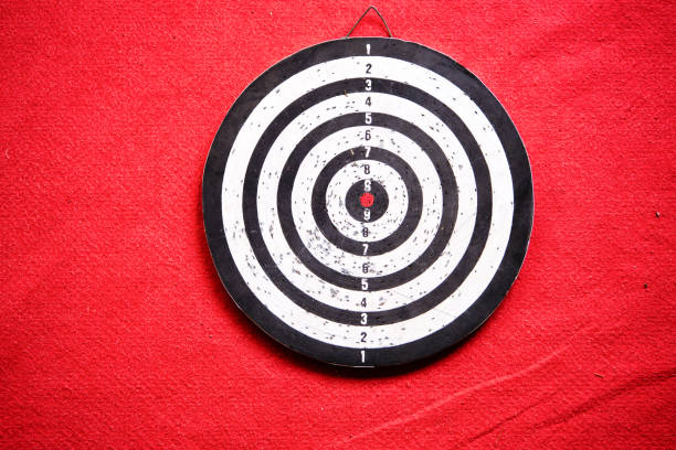 istock Already used and secondhand dart board standing on red carpet 1329320112