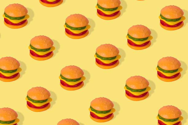 istock Creative trendy idea fast food pattern-  Hamburger on a yellow background 1329325920