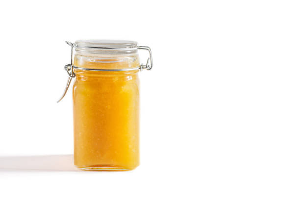 istock Homemade yellow jam in a jar on a white background. Fruit jam. Copy space. 1329326088