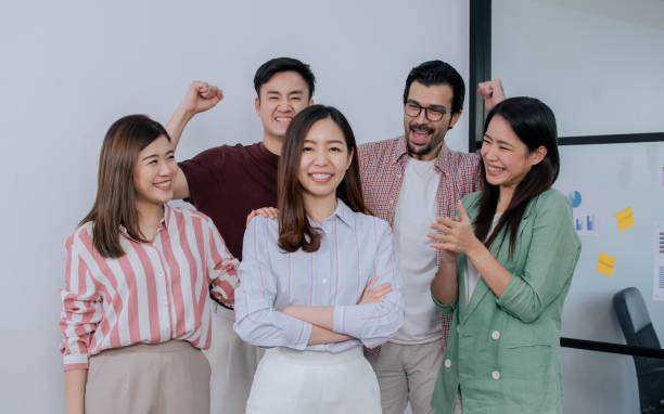 Group of mixed race people wearing casual business shirt, smiling with happiness and success, congrats and give applause to asian female leader. Group of mixed race people wearing casual business shirt, smiling with happiness and success, congrats and give applause to asian female leader Group of mixed race people wearing casual business shirt, smiling with happiness and success, congrats and give applause to asian female leader. stock photo stock pictures, royalty-free photos & images