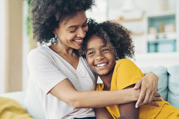 istock Smiling mother lovingly holding her daughter 1329328960