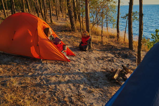 istock Woman exposing her face to sun from tent 1329332020