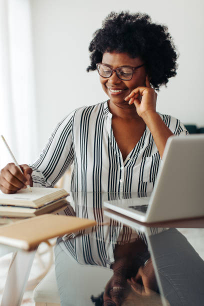 istock Businesswoman taking notes at home 1329332193