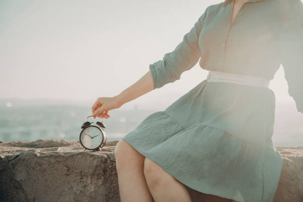woman holding alarm clock, holiday time