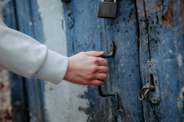 Old blue door  with woman hand