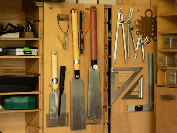 istock Above the carpenter's table, on the wall, there are shelves with various carpentry tools. 1329334547