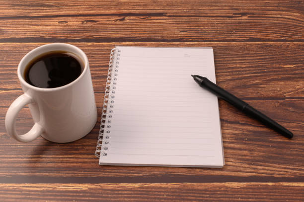 istock Coffee and a notebook are at your desk. 1329334703