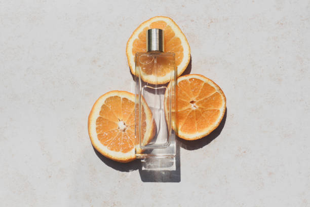 istock Transparent perfume bottle on orange slices 1329340120