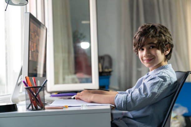 istock Elementary Schoolboy Homeschooling In Living Room 1329341071