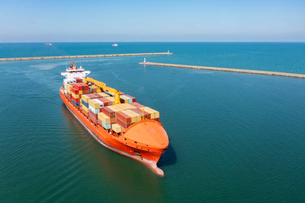 istock Aerial view of Cargo Container Ship approaching port with tugboat. 1329341706