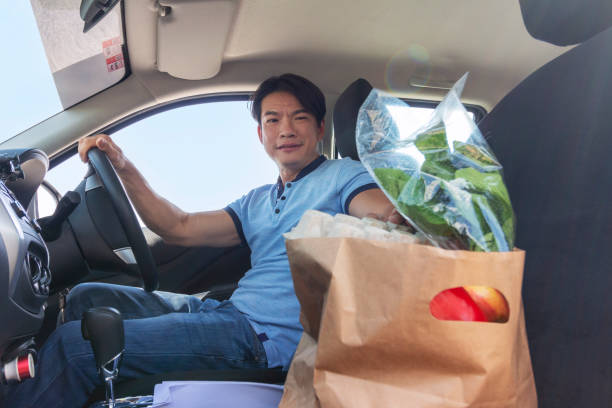 istock Man checking groceries in car 1329342001
