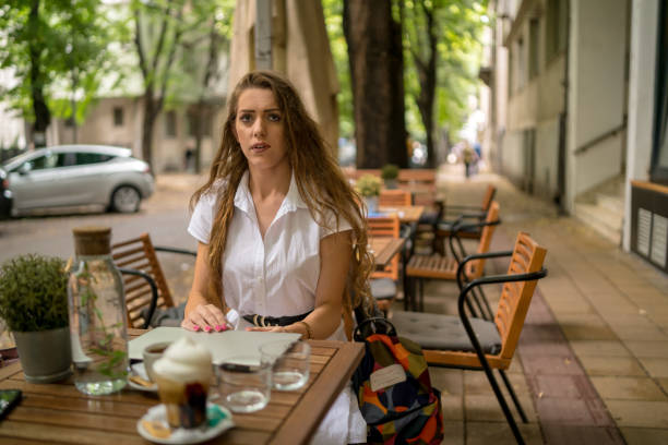 istock Businesswoman using laptop while enjoying work at cafe table with cup of coffee 1329343904