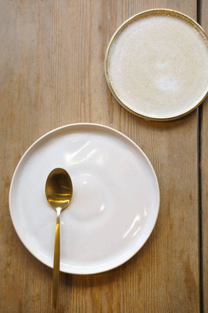 istock Golden kitchen set on wooden tabel. White plates 1329344398