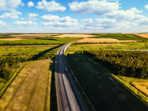 istock Aerial view of a highway going through agricultural fields at sunset 1329345081