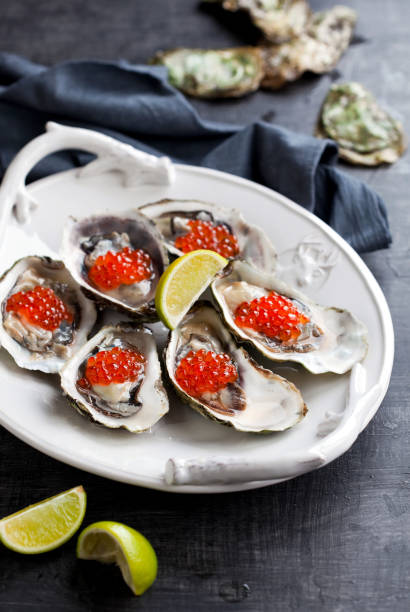 istock Fresh oysters, garnished with red caviar 1329346111