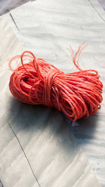 istock Orange twine ball on grey wood sheet 1329346206