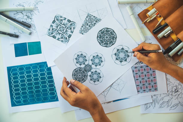 istock Designer designing drawing sketch pattern geometric flower seamless wallpaper fabric textile fashion industry. artistic design studio. 1329347898