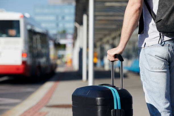 istock Passenger with suitcase waiting at bus station 1329348033