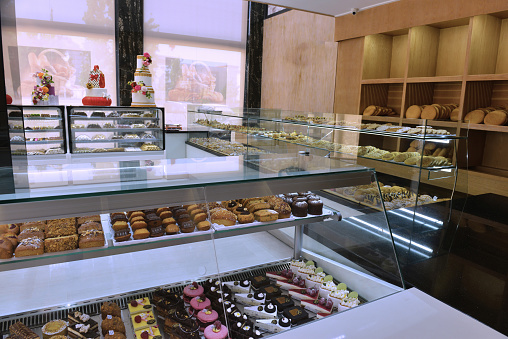 A display of French pastries and baked goods including a variety of donuts, coffee rolls, and muffins.
