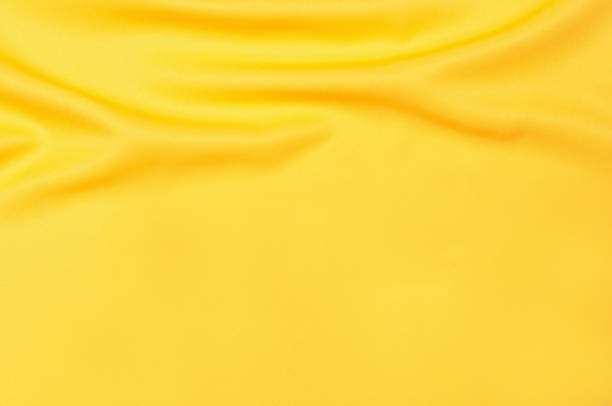 istock Smooth elegant yellow tissue abstract background. Textile background. Cloth wallpaper. Graphics design element 1329350611