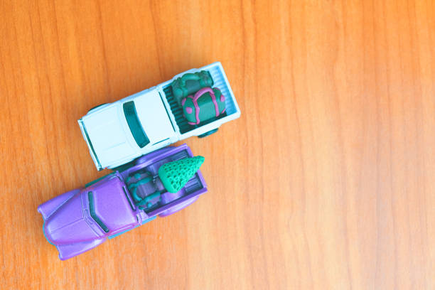 istock Small purple and white pickup automobiles on table. 1329351425