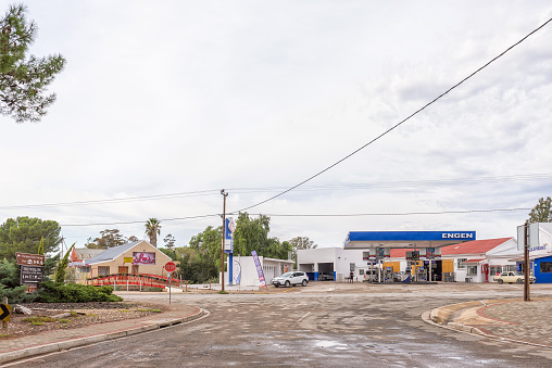 Willowmore, South Africa - April 21, 2021: A street scene, with a gas station and restaurant, in Willowmore in the Eastern Cape Province. A pedestrian bridge is visible