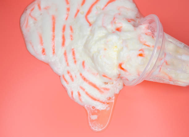 istock top view melted vanilla ice cream cup on a pink background 1329359308