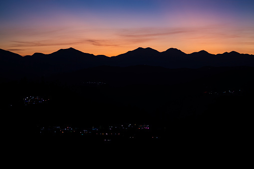 A silhouette of hills and some towns nearby the hills. Nilgiris,tamil nadu